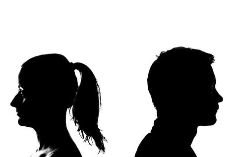 Silhouette of man and woman with their backs to each other