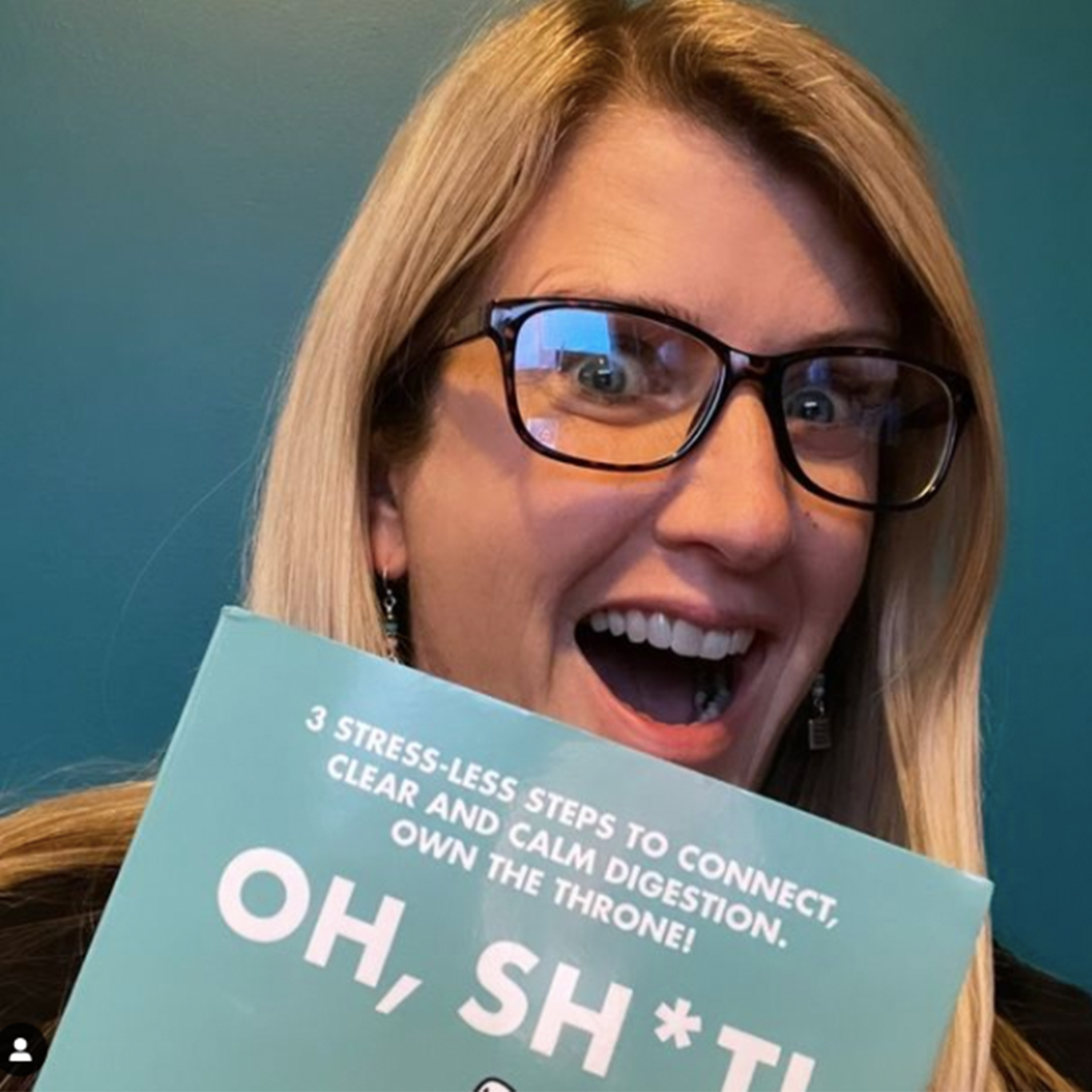 A smiling woman reading Dr. Marisol's book