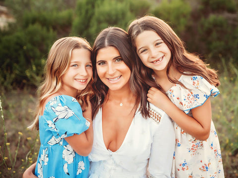 Woman posing with two daughters