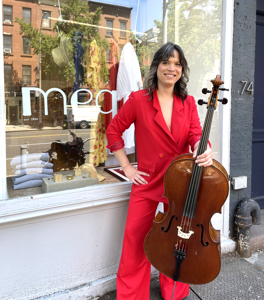 Andrew Yee poses with her cello outside of the Meg store.