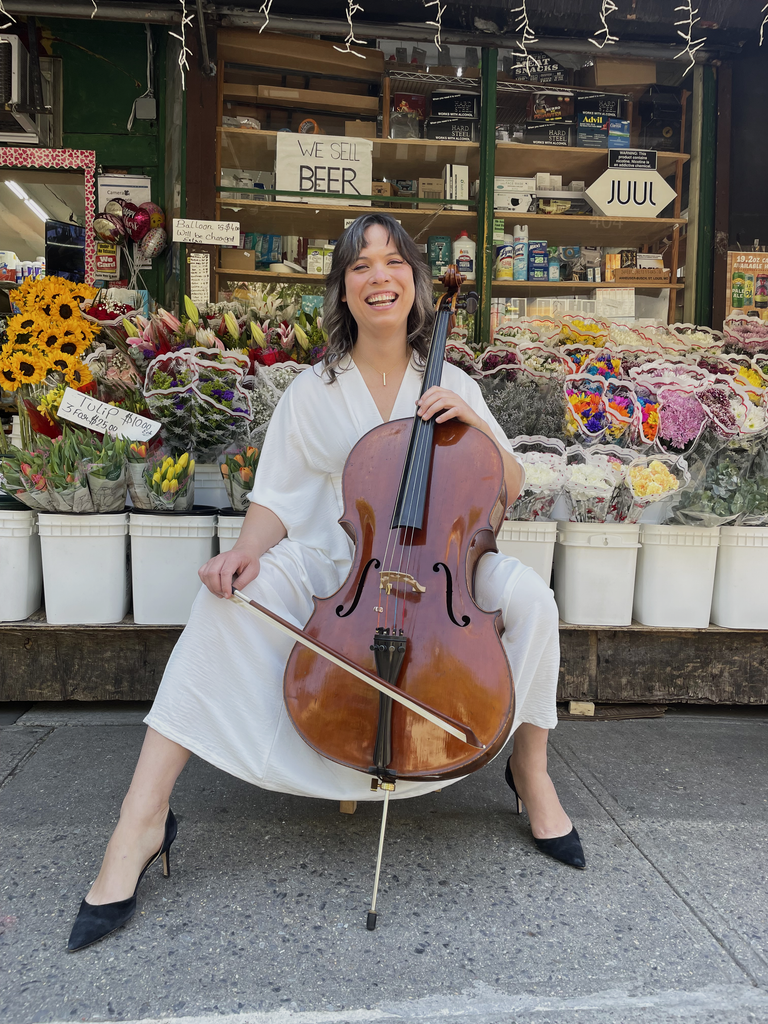 Andrew performing with her cello outside of the nearby bodega.