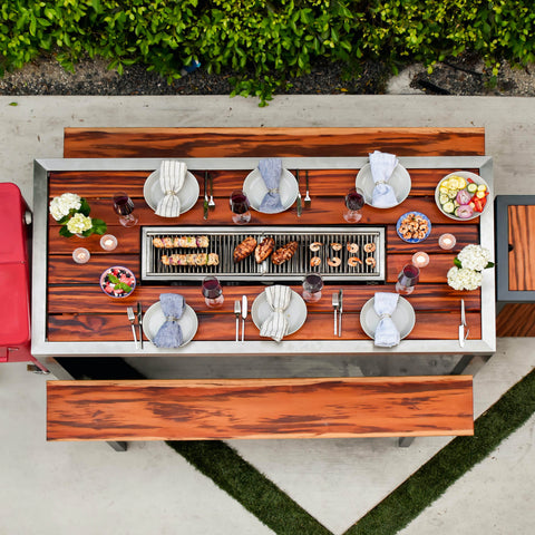 Outdoor kitchen with an Angara grilling table by iBBQ, Inc.