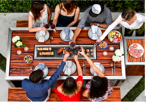 Friends eating at a modern outdoor dining grill table