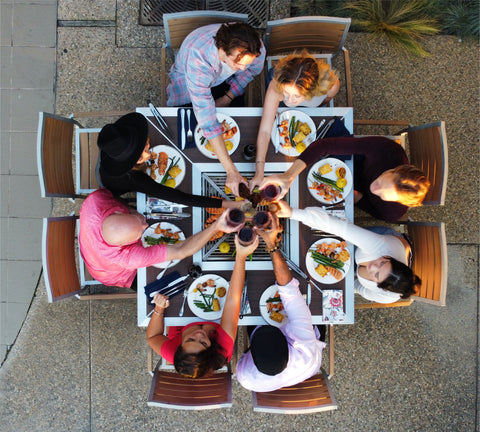 Friends celebrating around the Angara Quadra grilling table