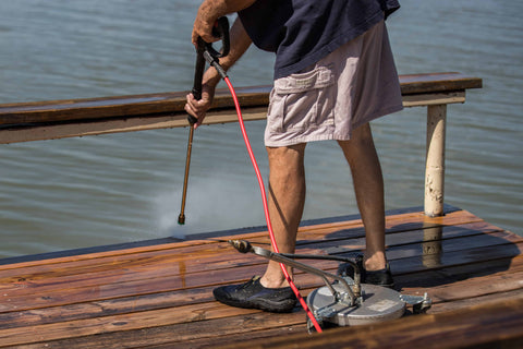 dock maintenance tips; man power washes deck