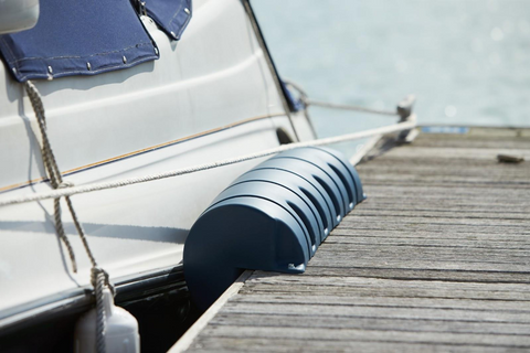 close up of dock fender protecting boat and wooden dock