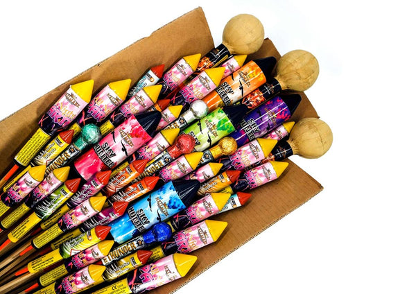 Cardboard box overflowing with a huge range of different firework rockets.