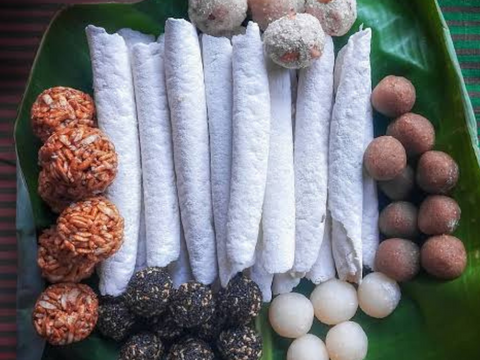 Til Pitha and other snacks served with tea in Assam