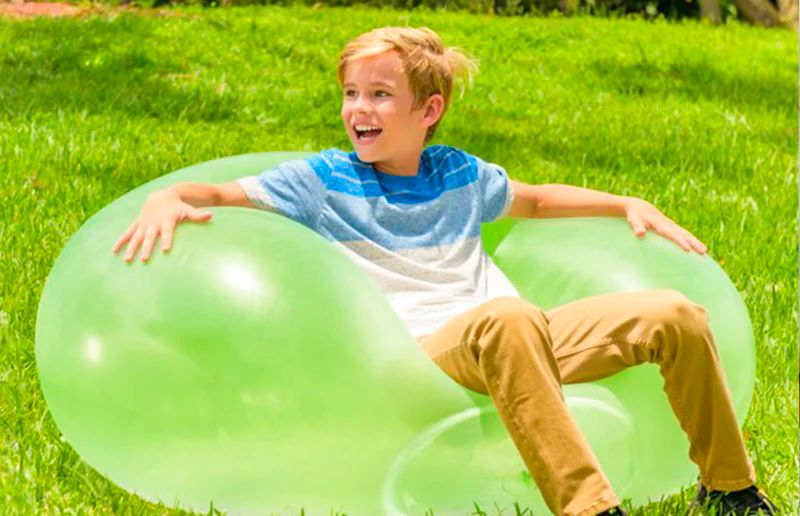 boy-sitting-on-a-giant-jelly-balloon-ball