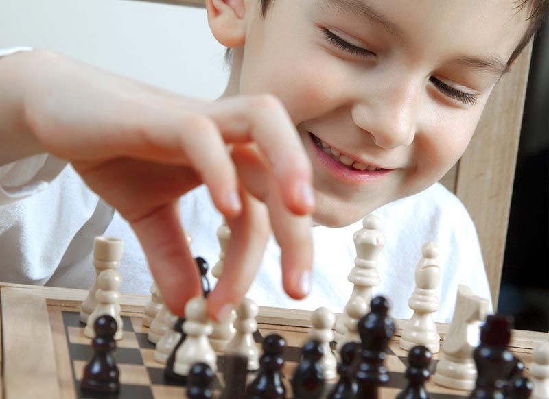 kid-smile-play-chess
