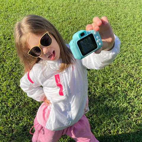 a granddaughter taking a selfie outdoors using the littlelens camera