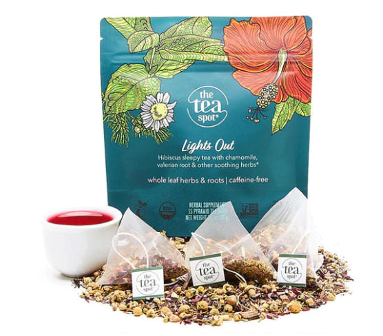 a bag of tea that reads Lights out with tea bags and loose leaf tea in front