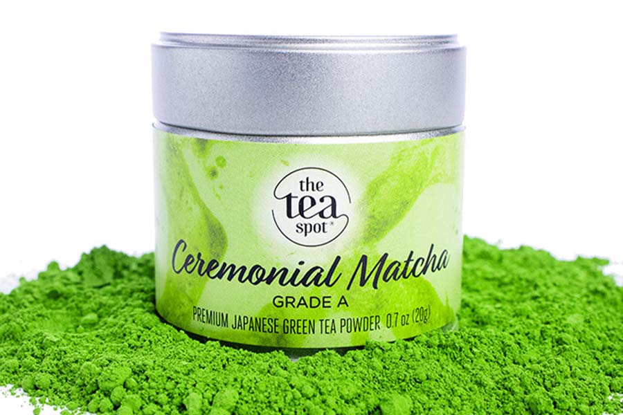 a tin reading ceremonial matcha sits on green matcha powder