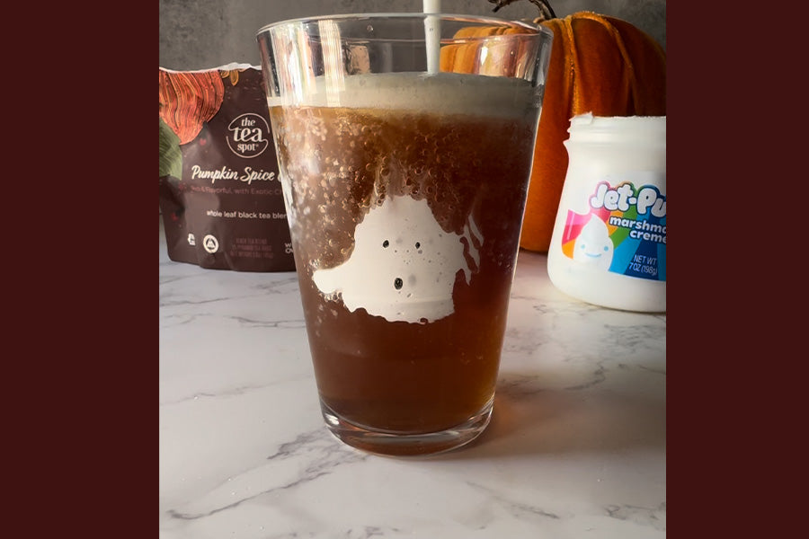 a pumpkin spice chai latte with a marshmallow ghost on the cup