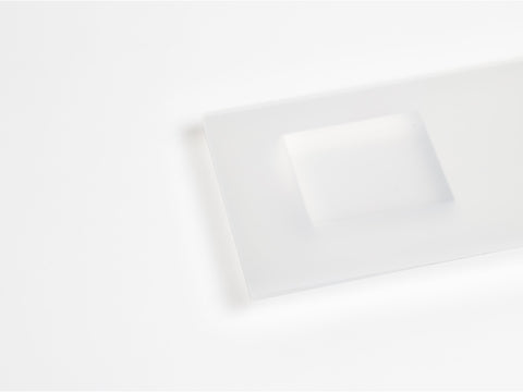 A frosted acrylic sheet and block on white background