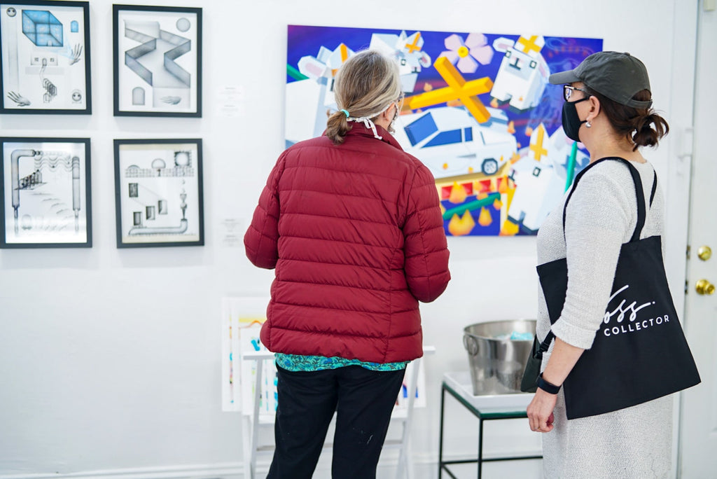Photograph of two women viewing artwork during Tim Irani and Neddie Bakula's "Double Vision" duo exhibition post analog surrealist VIP Collectors Event at Voss Gallery, San Francisco, February 2021.