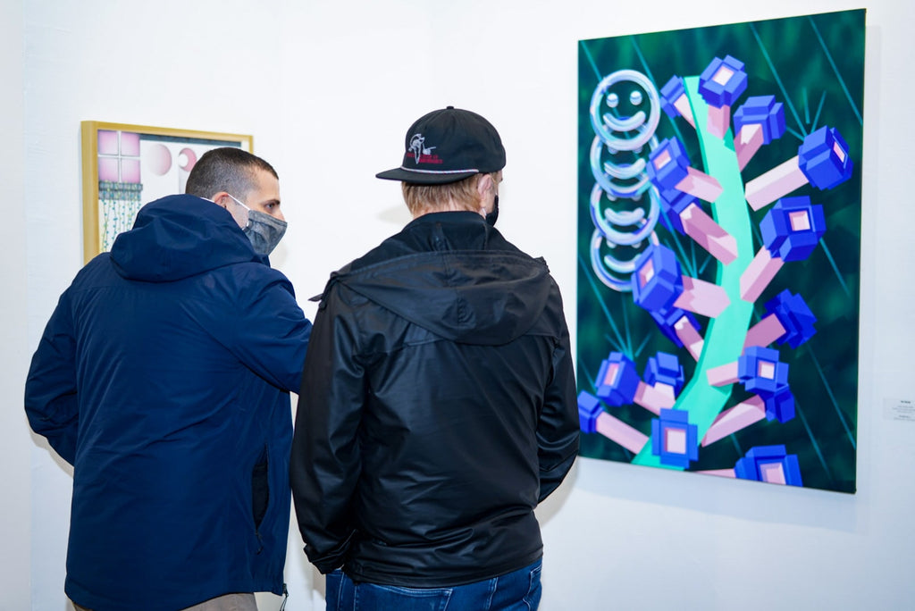 Photograph of two men viewing artwork during Tim Irani and Neddie Bakula's "Double Vision" duo exhibition post analog surrealist VIP Collectors Event at Voss Gallery, San Francisco, February 2021.