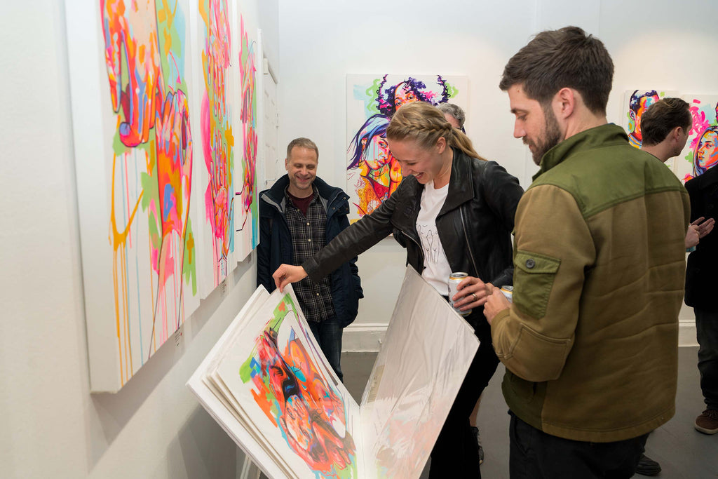 Young collectors looking at fine art prints by The Tracy Piper at Voss Gallery in San Francisco