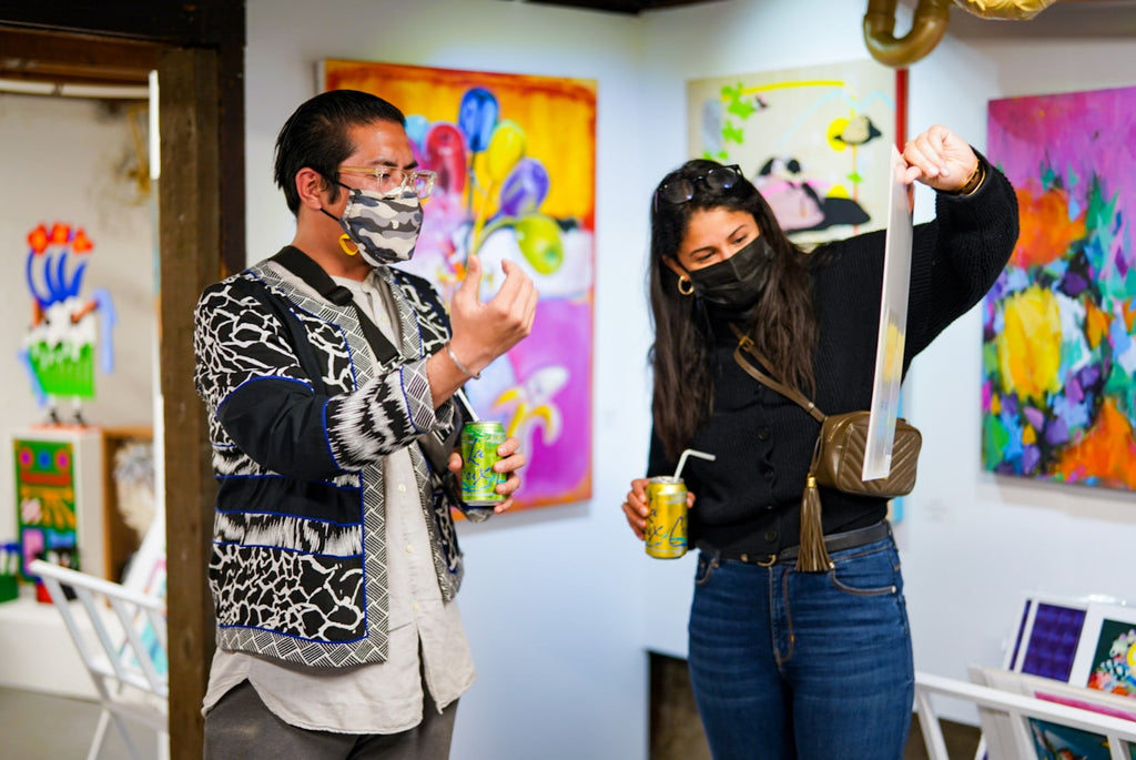 Two millennials looking at a fine art print at Voss Gallery in San Francisco