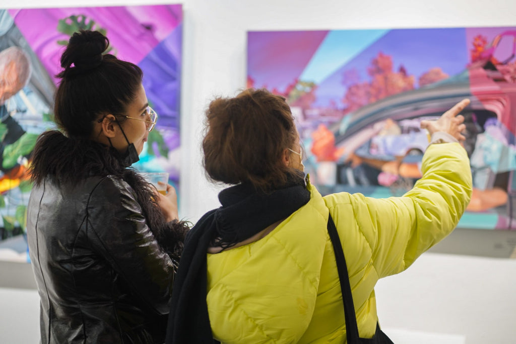 Photograph of two people viewing artwork during Ian Robertson-Salt's "Nine to Five" spotlight exhibition Opening Reception of New Contemporary paintings at Voss Gallery in San Francisco, January 2022.