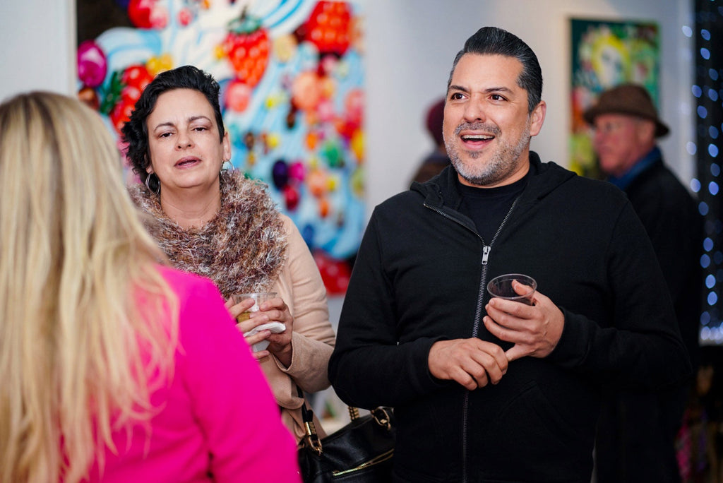 Photograph during Ingrid V. Wells's "Sweet Fascination" solo exhibition Opening Reception of kitschy oil paintings at Voss Gallery in San Francisco, March 2020.