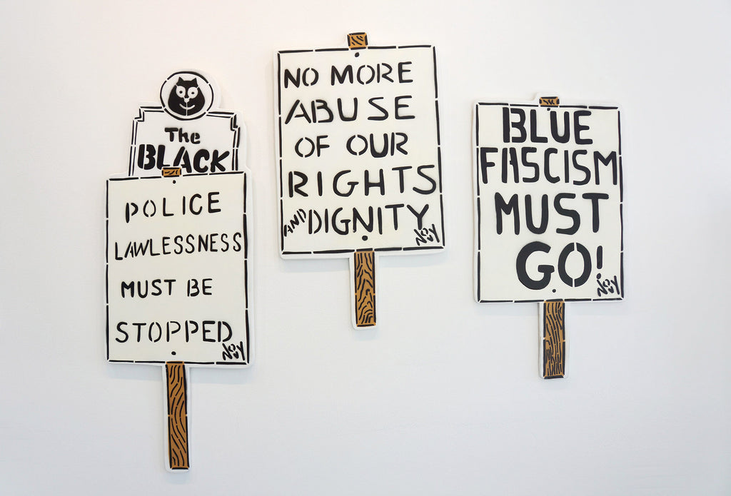 Image of signs artwork on the wall during Jeremy Novy's "The First Pride was a Riot" solo exhibition at Voss Gallery, San Francisco, June - July 2020.