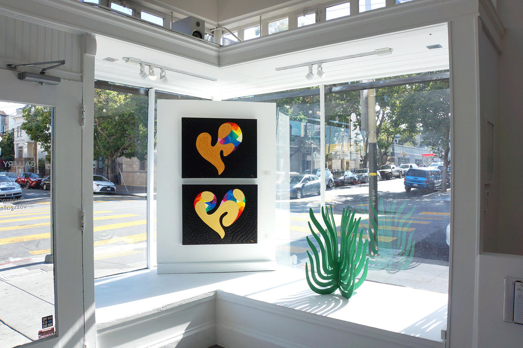 Photograph of  yellow/gold hearts in black background artwork during Jeremy Novy's "The First Pride was a Riot" solo exhibition at Voss Gallery, San Francisco, June - July 2020.