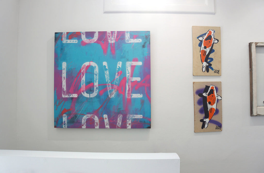 Photograph of artwork with texts "LOVE" on it and two koi fishes during Jeremy Novy's "The First Pride was a Riot" solo exhibition at Voss Gallery, San Francisco, June - July 2020.