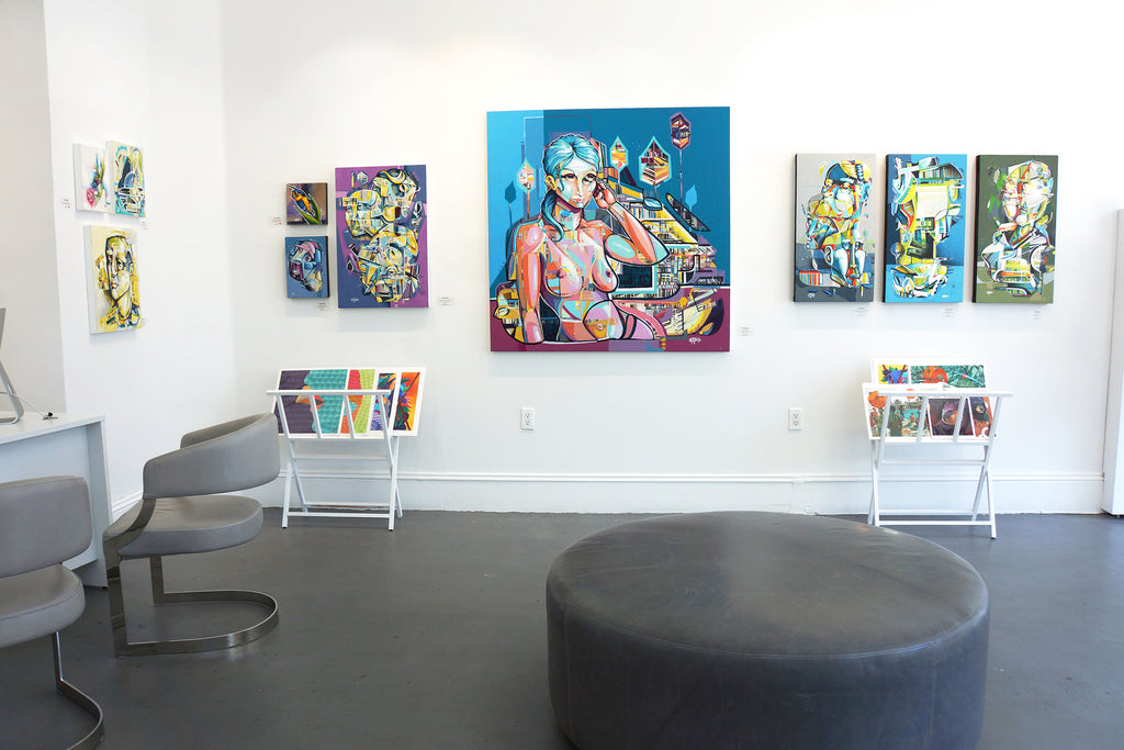 Photograph of paintings, a desk and chairs at Voss Gallery in San Francisco during John Osgood's "In Plain Sight" solo exhibition, May-June 2020.