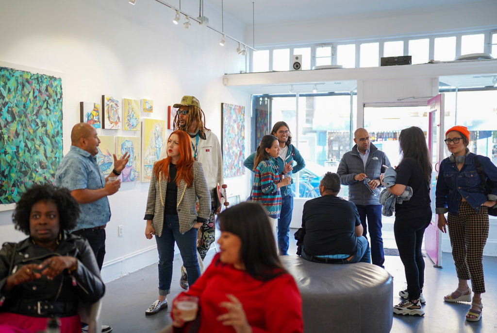 Photograph of attendees during the "Reflect.Renew.Rebirth" duo exhibition opening reception at Voss Gallery in San Francisco, July 21, 2023.