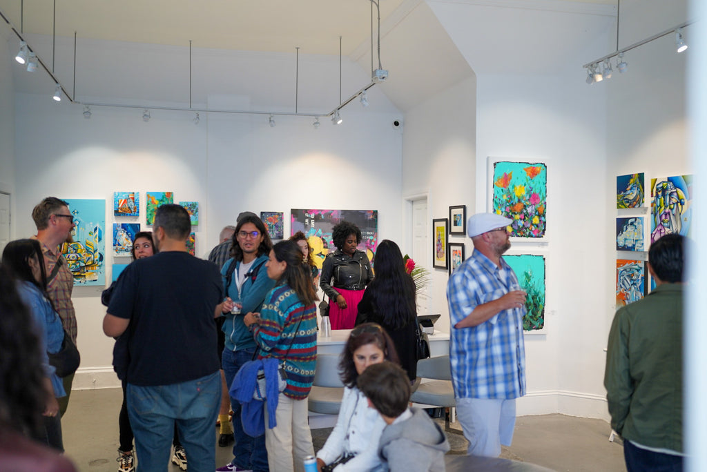 Photograph of guests celebrating the "Reflect.Renew.Rebirth" duo exhibition opening reception at Voss Gallery in San Francisco, July 21, 2023.