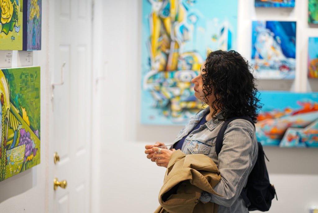 Photograph of a lady viewing artwork during the opening of the "Reflect.Renew.Rebirth" duo exhibition at Voss Gallery in San Francisco, July 21, 2023.