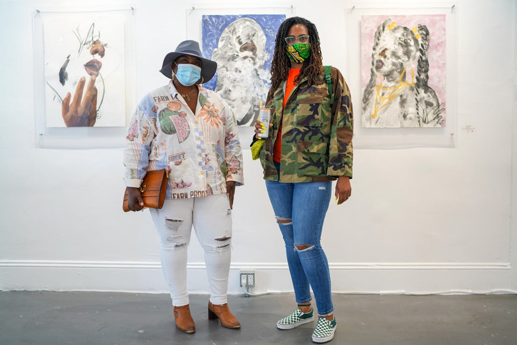 Photograph of two women wearing face masks during Khari Turner's "Hella Water" solo exhibition Opening Reception at Voss Gallery, San Francisco, May 21, 2021.