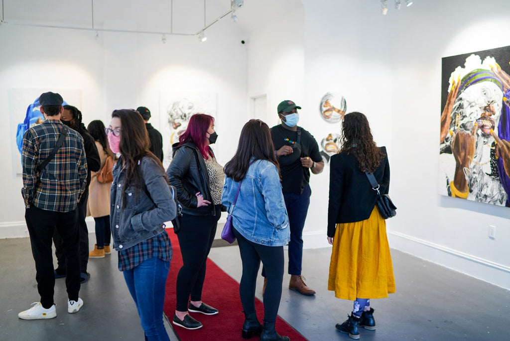 Photograph of gallery visitors talking to artist during Khari Turner's "Hella Water" solo exhibition Opening Reception at Voss Gallery, San Francisco, May 21, 2021.