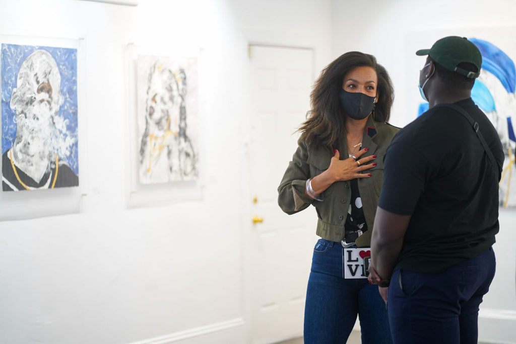 Photograph of a lady guest talking to artist during Khari Turner's "Hella Water" solo exhibition Opening Reception at Voss Gallery, San Francisco, May 21, 2021.