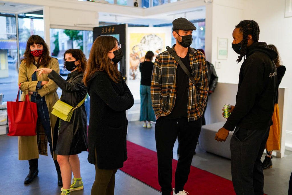 Photograph of people discussing during Khari Turner's "Hella Water" solo exhibition Opening Reception at Voss Gallery, San Francisco, May 21, 2021.