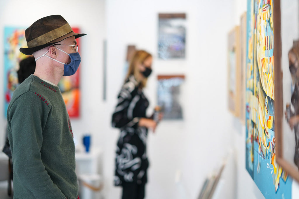 Photograph of people viewing artwork during the "Layers" opening reception featuring work by John Osgood and Trent Thompson at Voss Gallery, San Francisco on August 6, 2021.