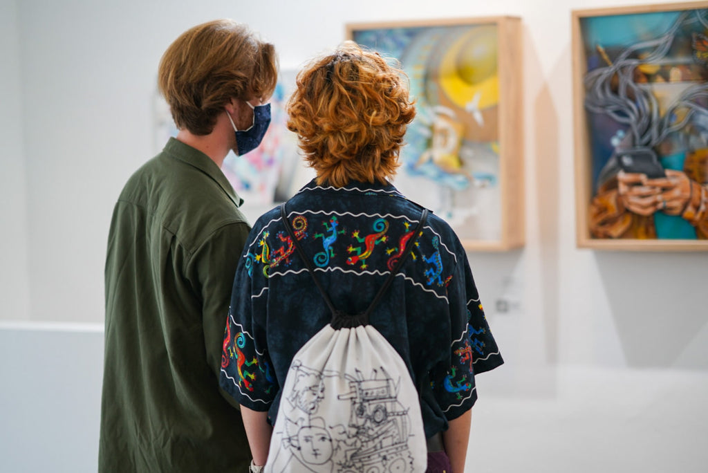 Photograph of people viewing artwork during the "Layers" opening reception featuring work by John Osgood and Trent Thompson at Voss Gallery, San Francisco on August 6, 2021.