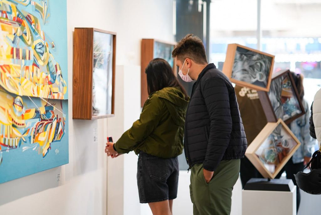 Photograph of people viewing artwork during the "Layers" opening reception featuring work by John Osgood and Trent Thompson at Voss Gallery, San Francisco on August 6, 2021.