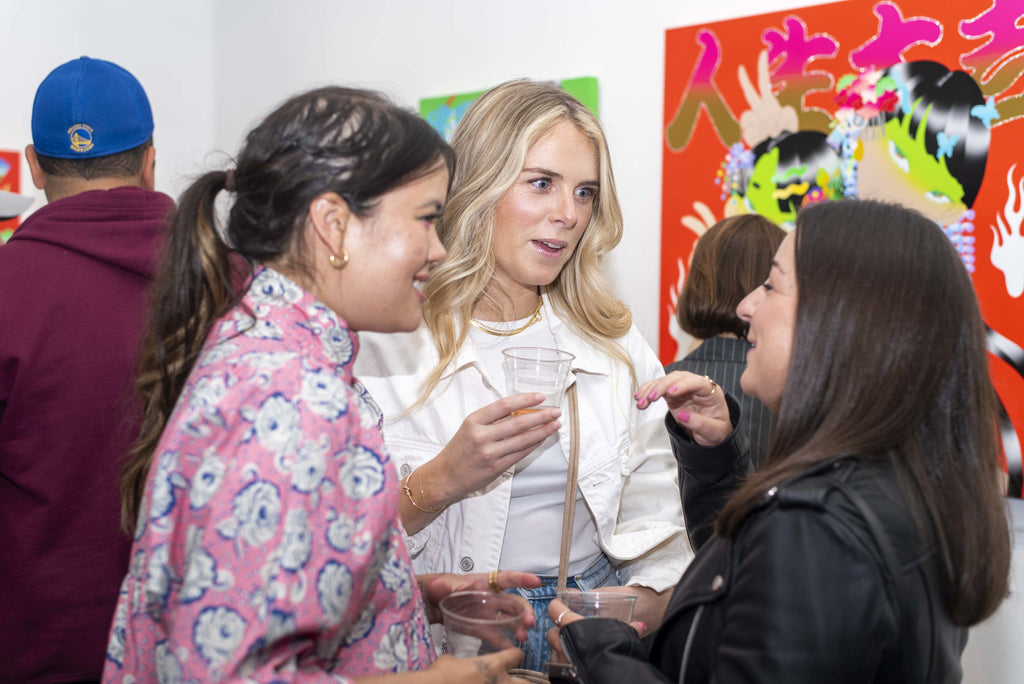 Photograph of three women discussing during Maya Fuji's "Kami" solo exhibition Opening Reception at Voss Gallery in San Francisco, May 27, 2022.