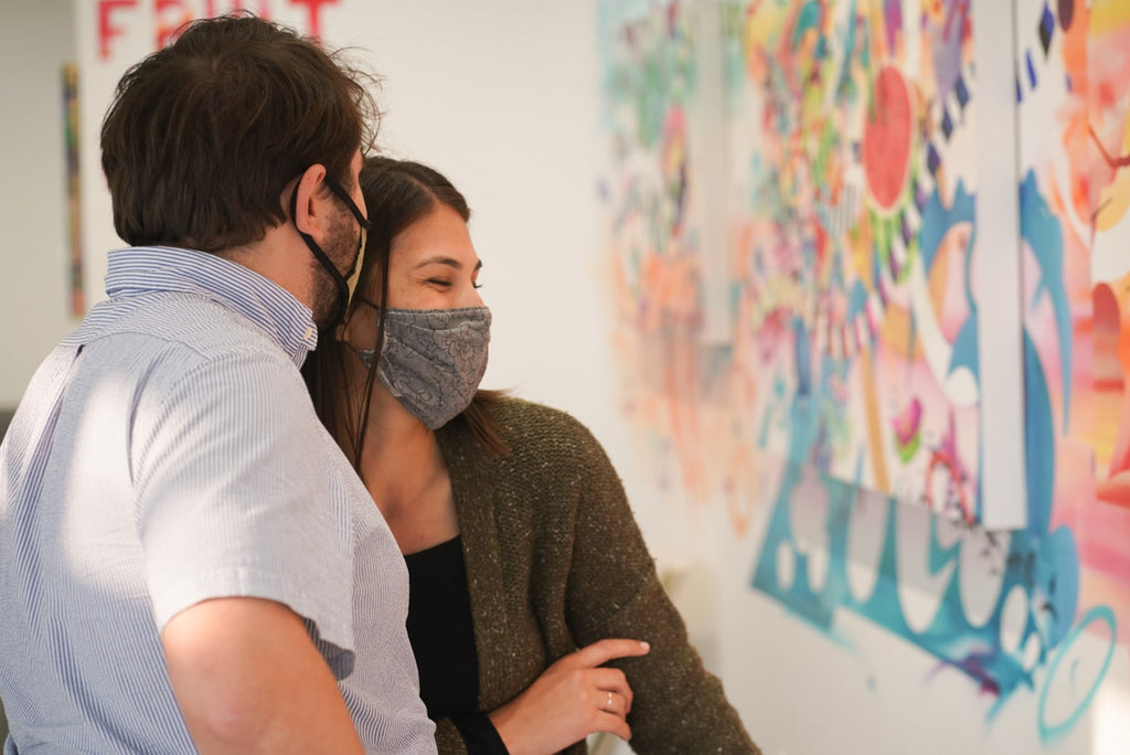 Photograph of a couple viewing artwork during Joshua Nissen King's "Fruit of Another"solo exhibition Meet the Artist Event at Voss Gallery, San Francisco, September 12, 2020.