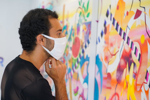 Photograph of a man wearing a face mask looking at a painting during Joshua Nissen King's "Fruit of Another"solo exhibition Meet the Artist Event at Voss Gallery, San Francisco, September 12, 2020.