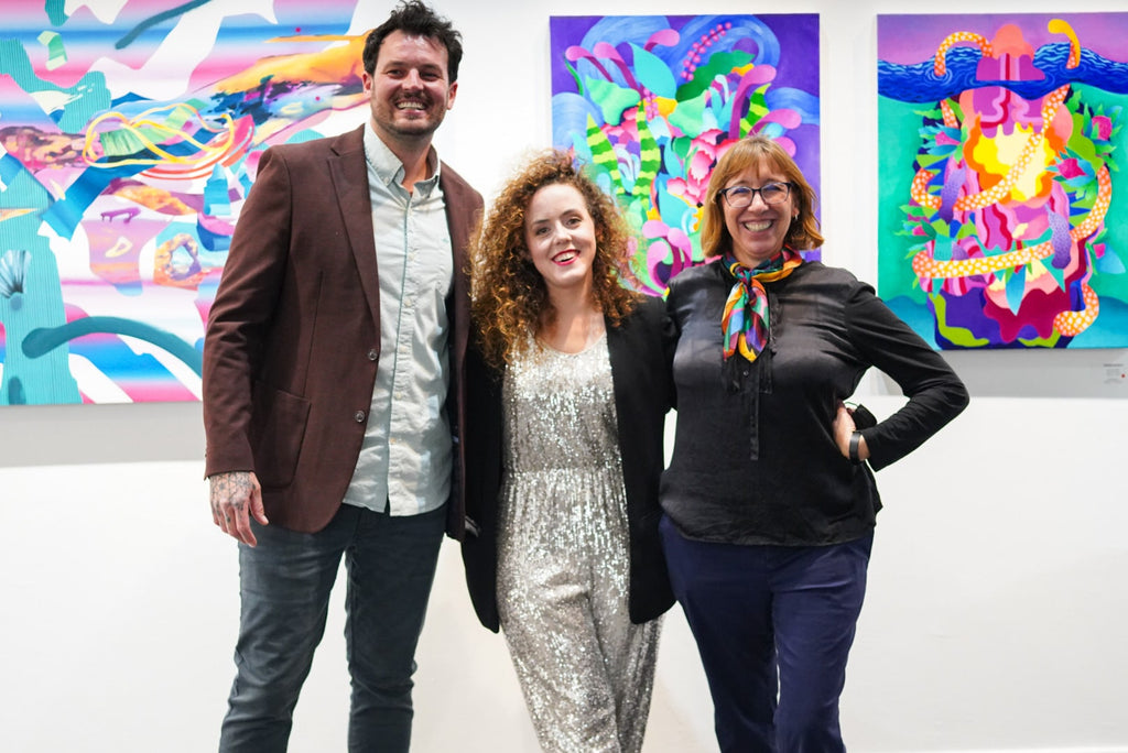 Photograph of gallery owner, Ashley L. Voss and artists, Joshua Nissen King and Jennifer Banzaca during Jennifer Banzaca & Joshua Nissen King's "Mirage" duo exhibition Opening Reception at Voss Gallery, October 22, 2021.