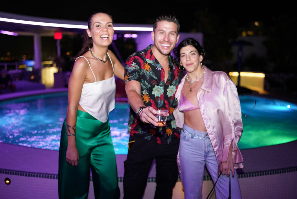 Friends attending The Tracy Piper and Voss Gallery's Art Basel Happy Hour event during Miami Art Week 2022 at Moxy South Beach.