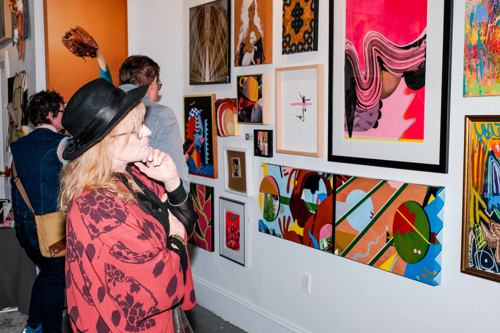 Photograph of a lady viewing artwork during the Opening Reception of the "Refusés of the Bay" Group Exhibition at Voss Gallery, San Francisco, September 29, 2023.