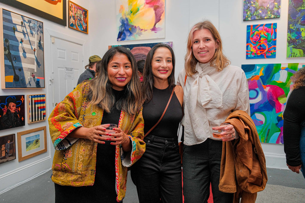 Photograph of three art enthusiasts attending the opening night of the "Refusés of the Bay" Group Exhibition at Voss Gallery, San Francisco, September 29, 2023.