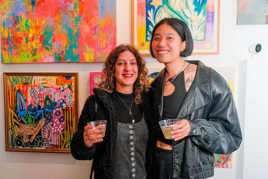 Photograph of two female attendees at the opening night of the "Refusés of the Bay" Group Exhibition at Voss Gallery, San Francisco, September 29, 2023.