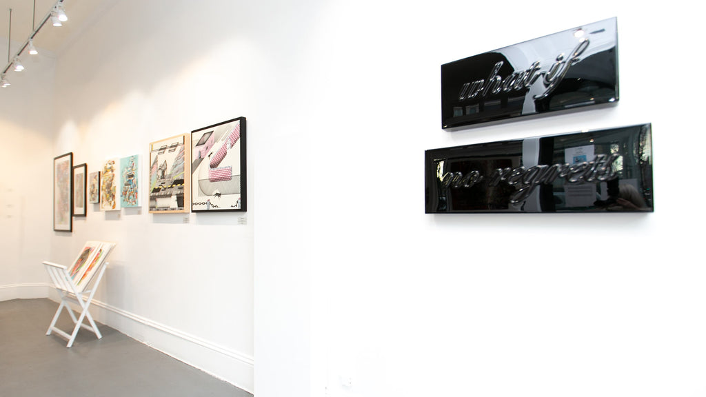 Install image of "The Essentials" group exhibition at Voss Gallery, San Francisco in December 2019-February 2020. Photograph of Lucky Rapp's work hanging in the spotlight wall of the gallery.
