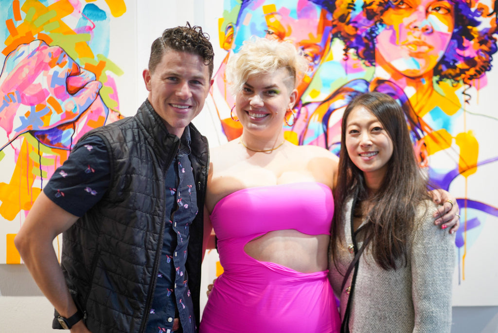 Photograph of a two guests with the artist, The Tracy Piper during the opening reception of her "All the Feels" solo exhibition at Voss Gallery, San Francisco, August 25, 2023.