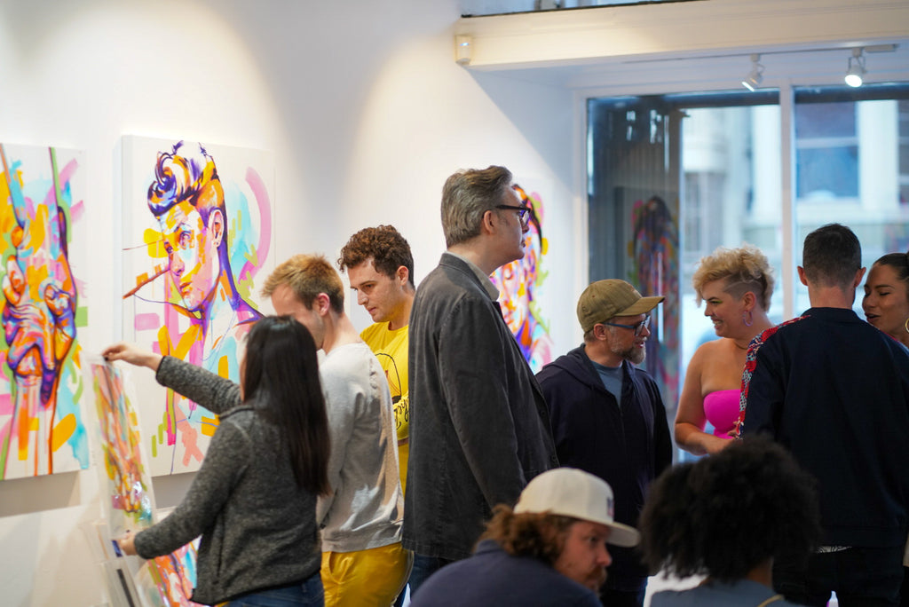 Photograph of people viewing artwork during the opening reception of The Tracy Piper's "All the Feels" solo exhibition at Voss Gallery, San Francisco, August 25, 2023.